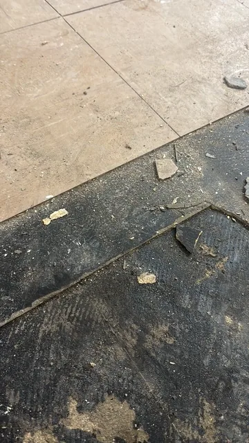 Black bitumen mastic floor removal in a SW2 flat